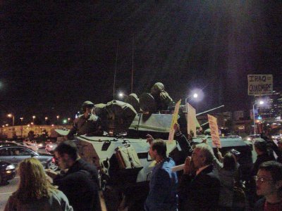 photo: Anti-war demonstrators facing a tank in the streets